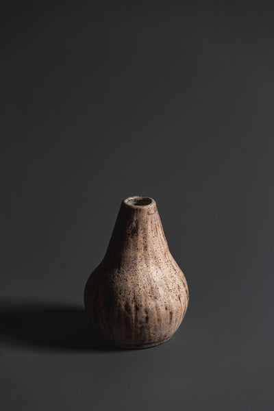  Handcrafted in natural tones and organic in nature this ceramic vase is a unique Australian homeware piece to adorn your home.  Type: Ceramic Vase  Materials: Stoneware  Dimensions: 140 x 110mm
