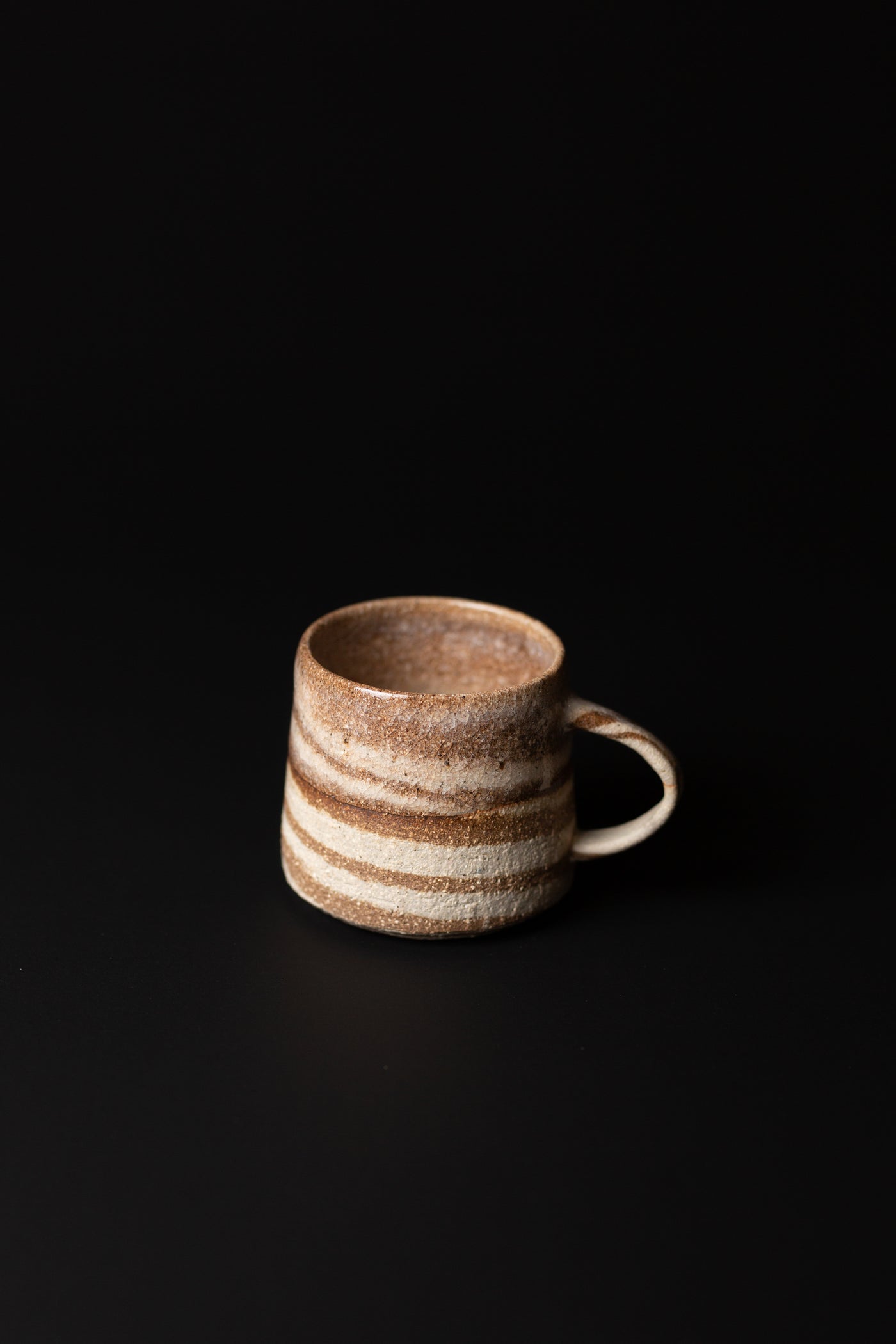 Handmade with traditional wheel-thrown techniques and fired at high temperatures for durability. This handcrafted mug is a natural, beautiful piece of Australian homeware. Type: Mug  Colour: White and Brown  Materials: Mixed Clay - Stoneware  Dimensions: 120 x 80mm     240mls