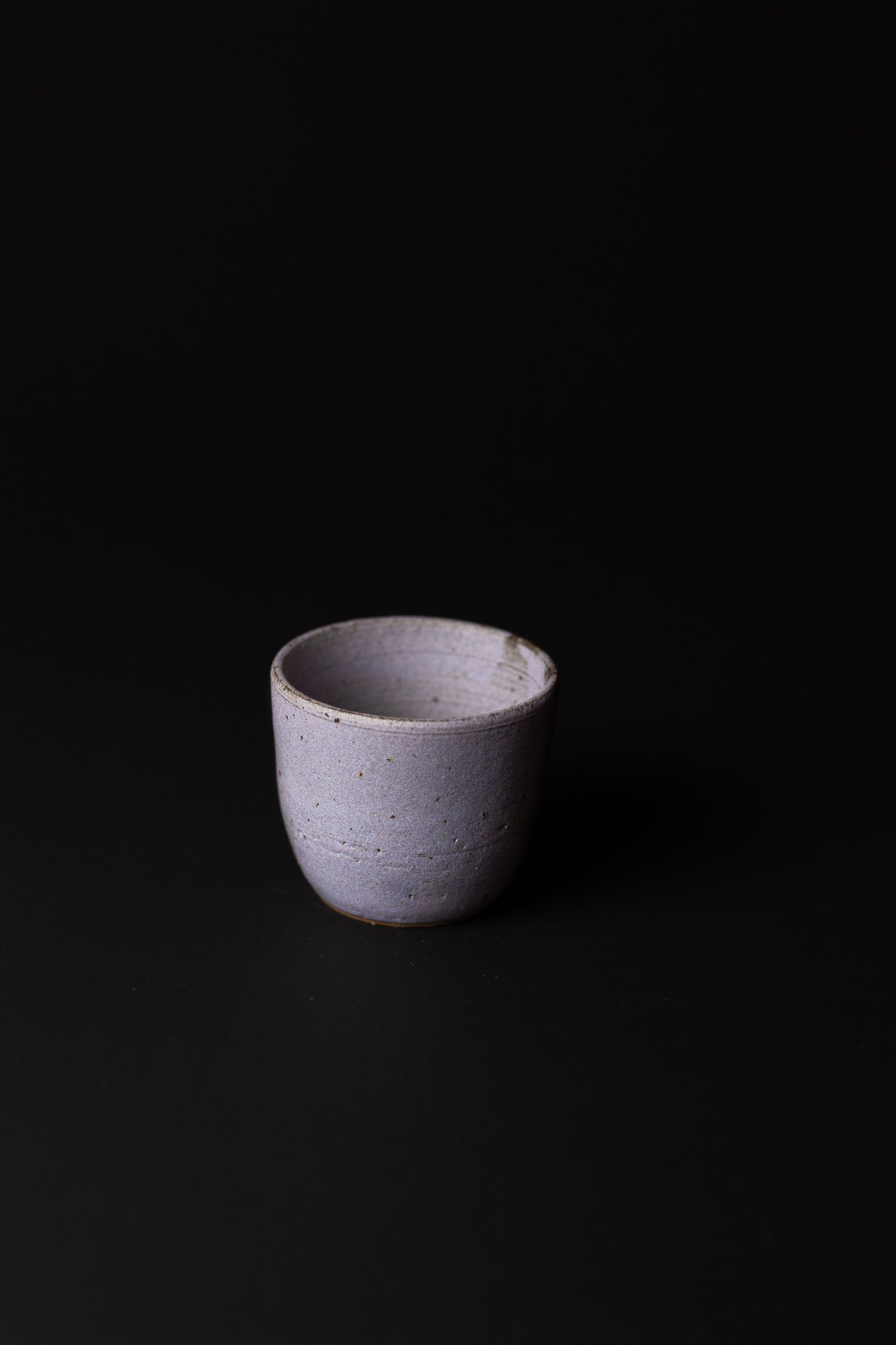 Handcrafted in Melbourne, Bec's connection with clay form has an Asobimasu playfulness. Using recycled clay and glazing, this organic cup embodies the acceptance of oddity and imperfection.  Type: Cup  Material: Stoneware  Dimensions: 80 x 70mm 