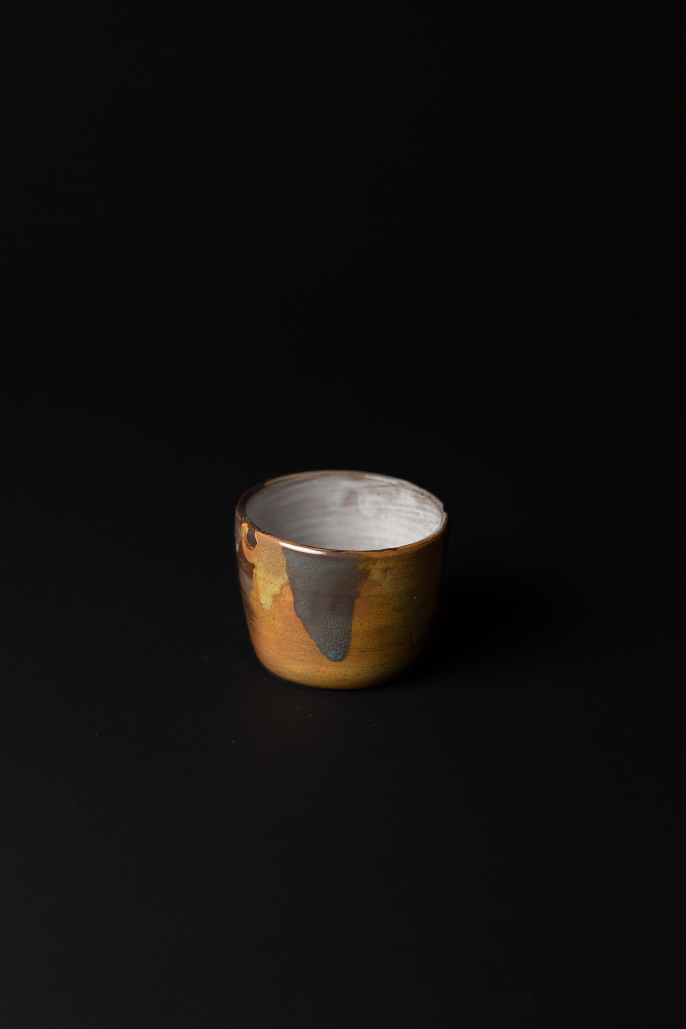Handcrafted in Melbourne, Bec's connection with clay form has an Asobimasu playfulness. Using recycled clay and glazing, this organic cup embodies the acceptance of oddity and imperfection.  Type: Tea Cup  Material: Stoneware  Dimensions: 140 x 65mm     140mls
