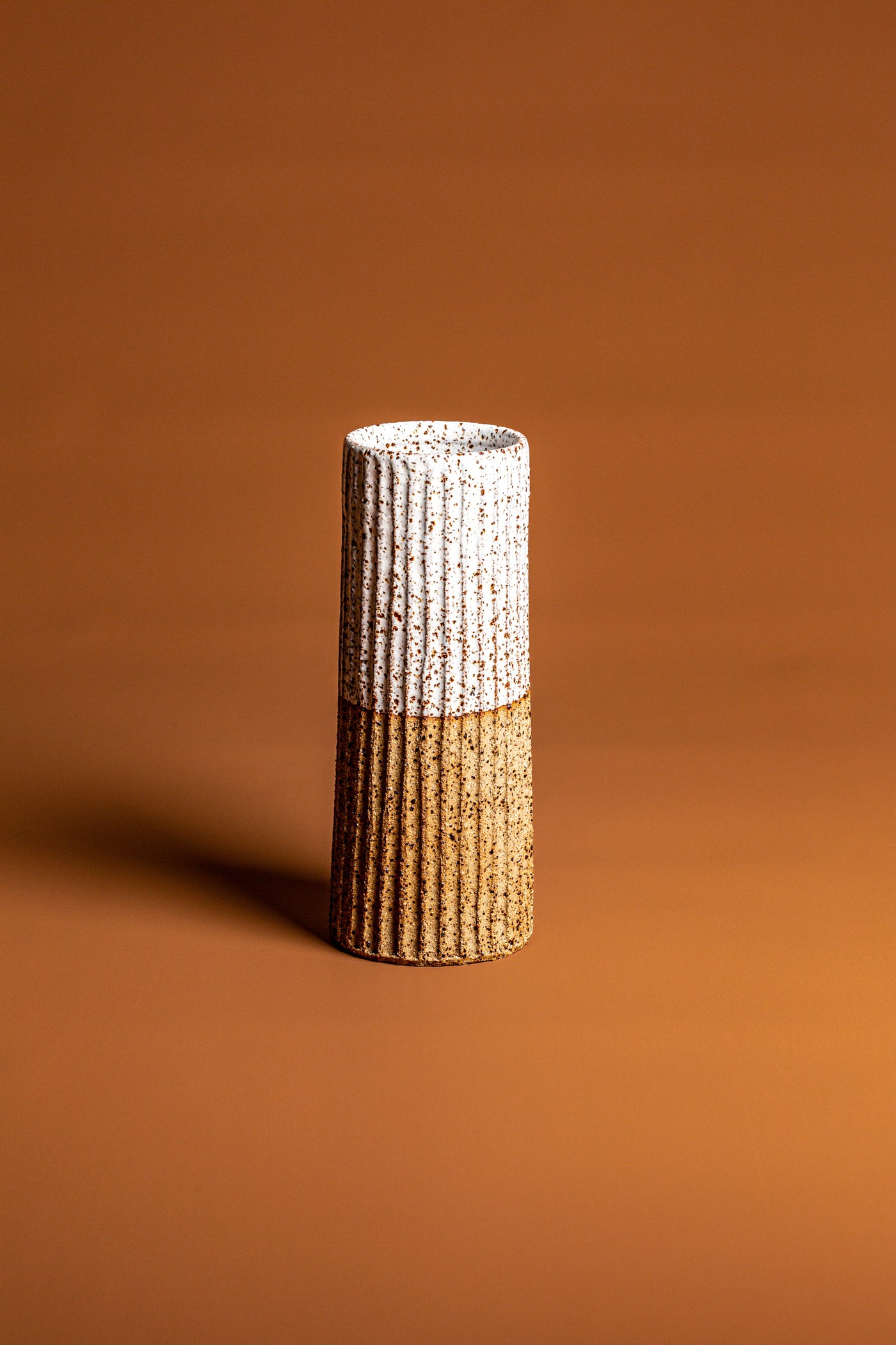 Handmade with traditional wheel-thrown techniques and fired at high temperatures for durability. This handcrafted vase is a natural, beautiful piece of Australian homeware. Type: Ceramic Vase  Colour: White and Brown  Materials: Stoneware  Dimensions: 220 x 85mm